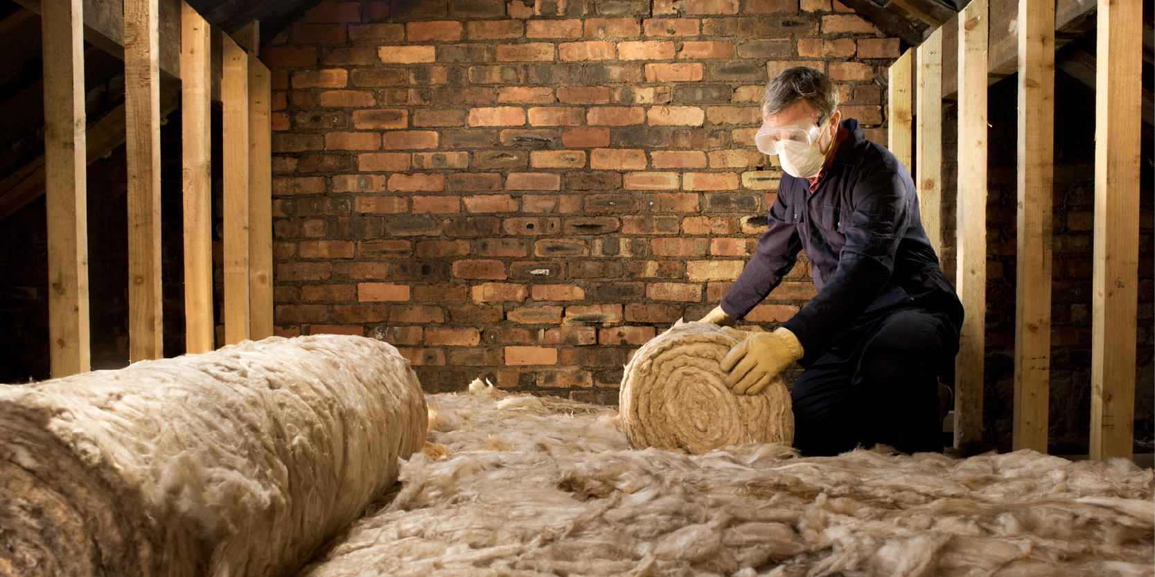 Someone insulating a loft.